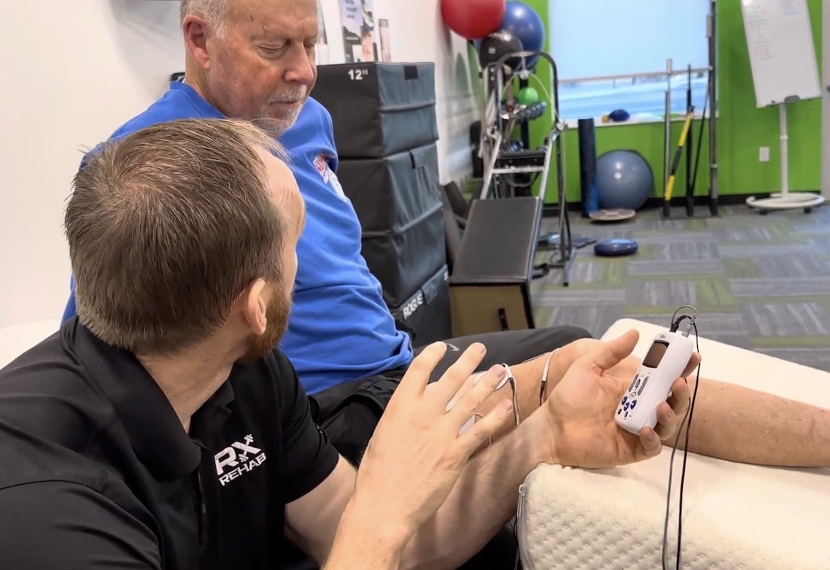 Man getting electrical stimulation from Scott Christensen at Rx Rehab